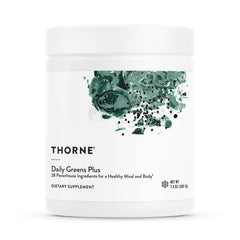 THORNE Daily Greens Plus mint powder in a glass for refreshing daily nutrition