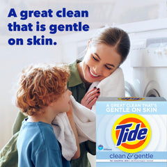 Pouring Tide Clean and Gentle powder into washing machine drum for a steady clean.