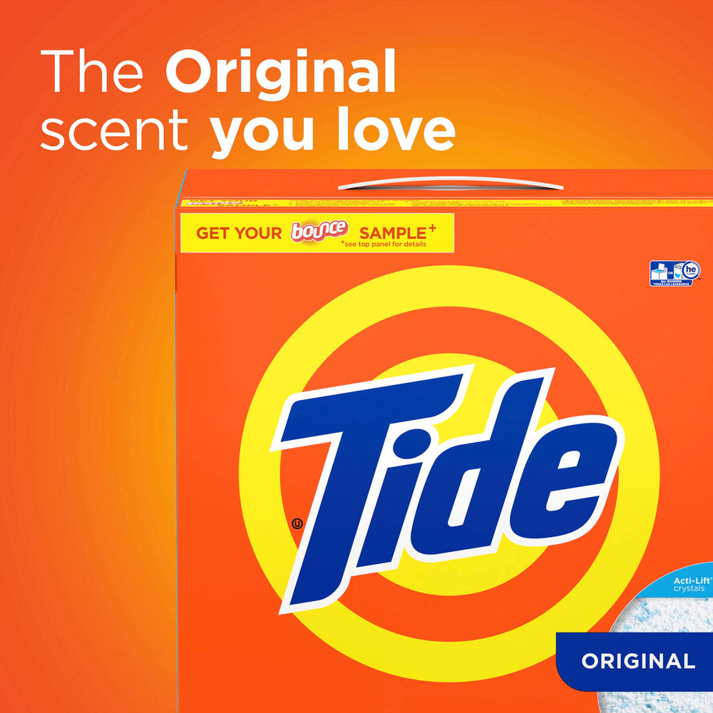 Pouring Tide Original Scent powder into washing machine for a thorough clean.