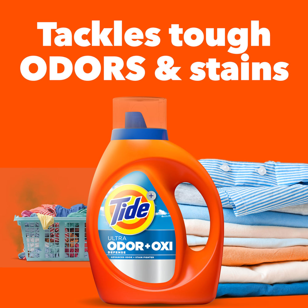 Tide Ultra Odor Defense Plus Oxi bottle being poured into a washer.