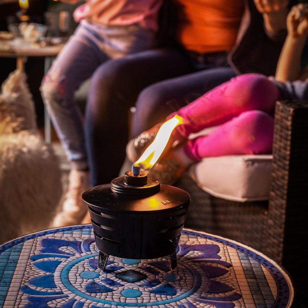 TIKI Mini Pit Table Torch features a long-lasting fiberglass wick for a steady flame.