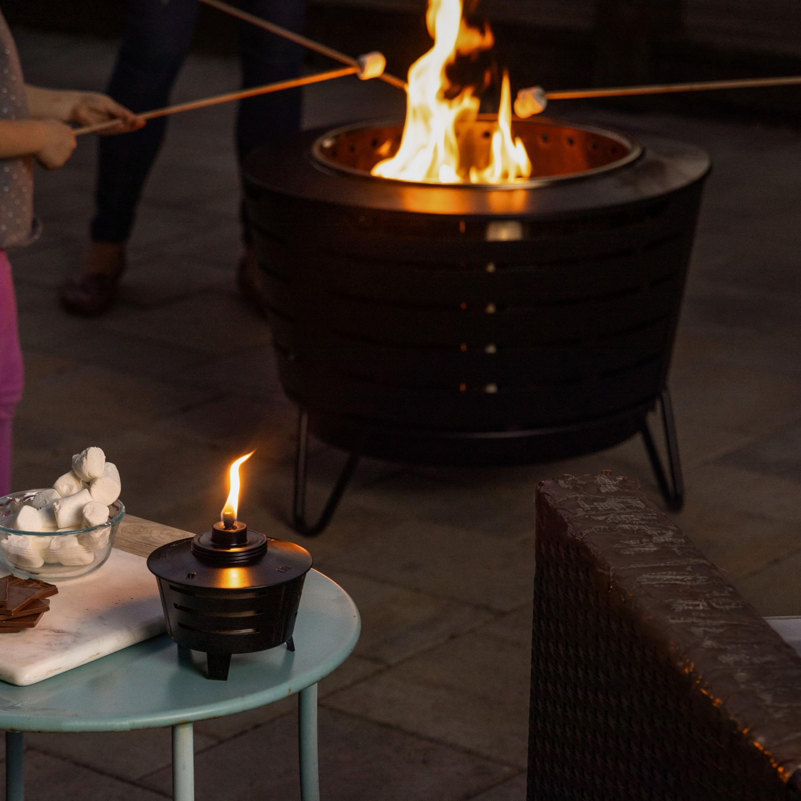 TIKI Mini Pit Table Torch creates warm ambience for evening outdoor gatherings.