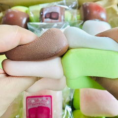 TIM CHESS sticky bread squishy on a desk, pink and green accents