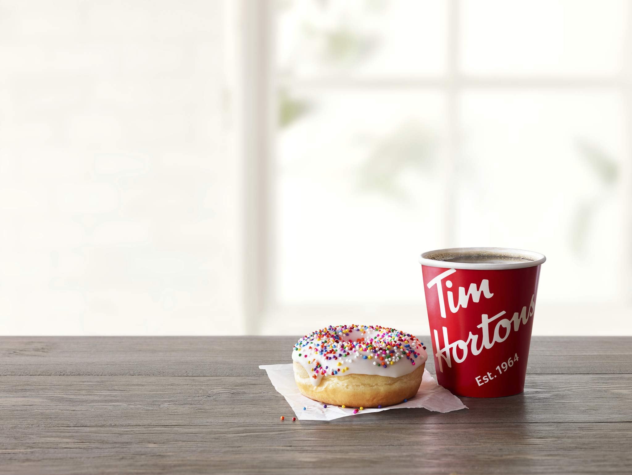 Tim Hortons cozy morning desk setup with coffee ready in seconds.