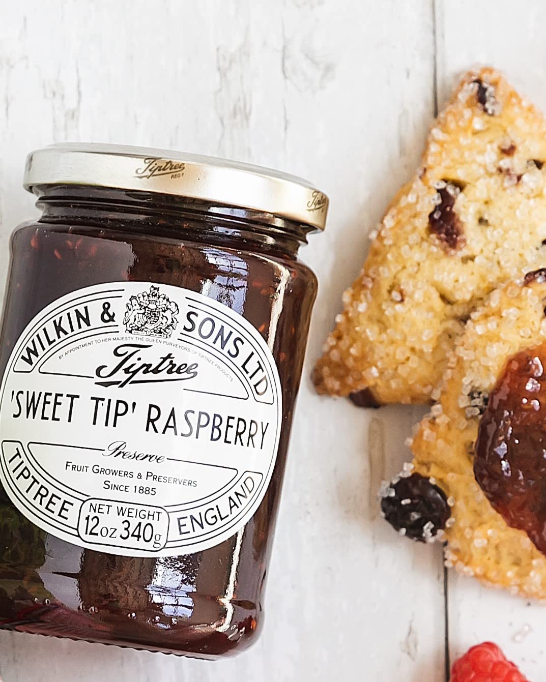 Tiptree Raspberry Preserve jar in a pantry, showing natural ingredients.