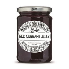 Tiptree Red Currant Jelly jar with a glossy spread, ideal for toast.