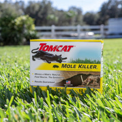 Tomcat Mole Killer strips held in hand showing simple placement.