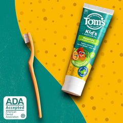 Tom's of Maine label detailing orange mango flavor and fluoride.