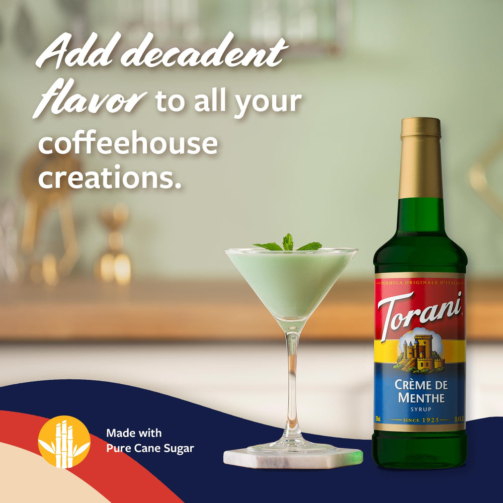 Torani Creme de Menthe syrup bottle beside a steaming latte for flavor experimentation.