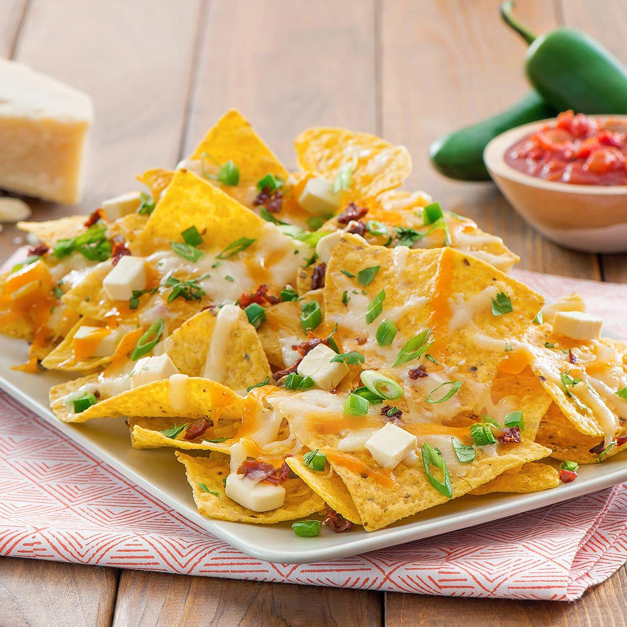 Tostitos Queso Variety Pack dips with tortilla chips on a party spread