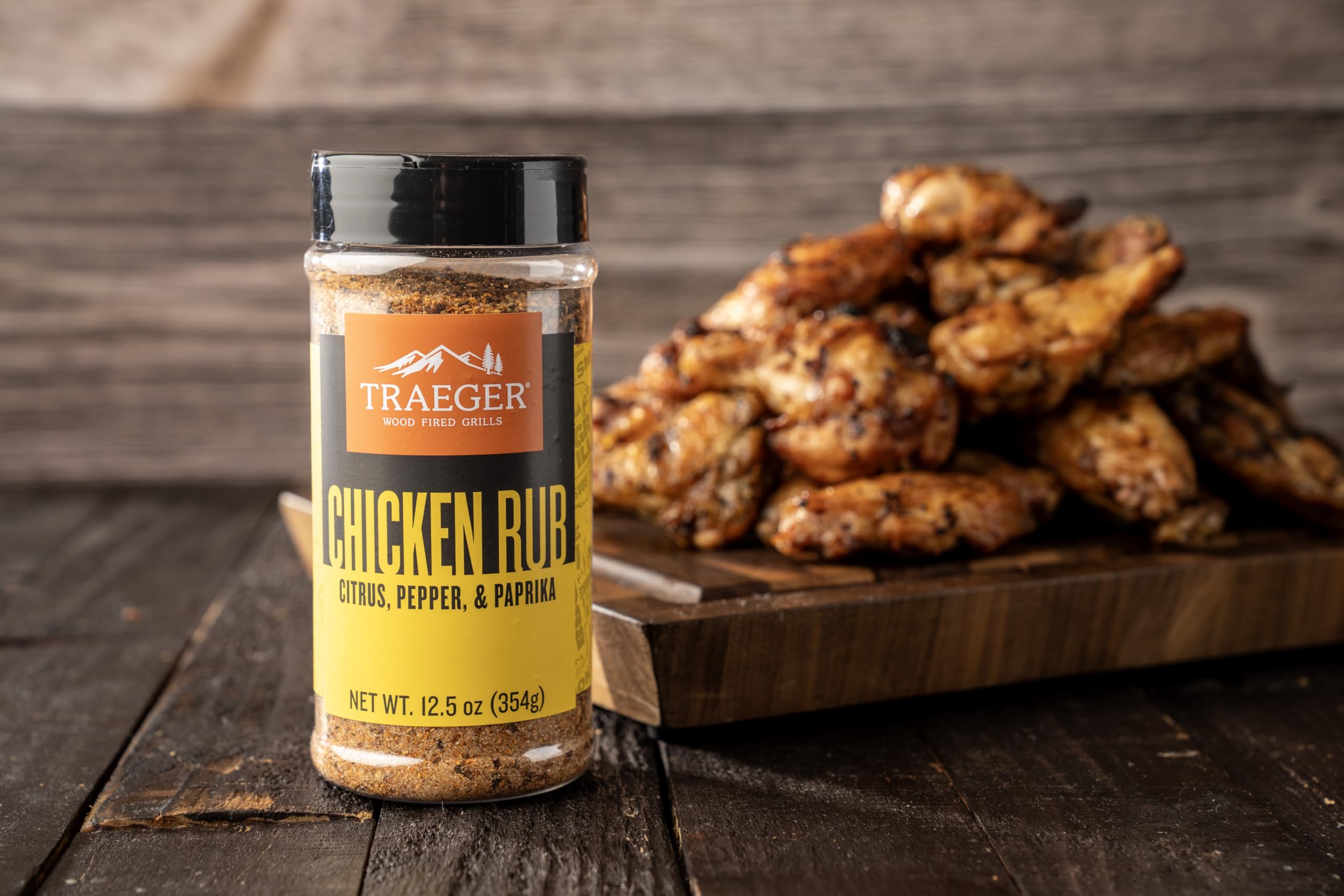 Traeger grilling chicken with rub on breast for enhanced aroma and color