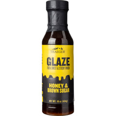 Traeger Honey & Brown Sugar Glaze bottle ready to glaze chicken for a glossy finish.