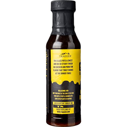 Brushing Traeger Honey & Brown Sugar Glaze onto chicken for color and flavor.