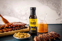 Pouring Traeger Honey & Brown Sugar Glaze over pork to caramelize.