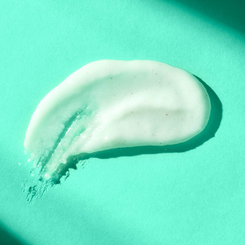 Close-up of Merry Mint scrub being scooped for smoother skin benefits.