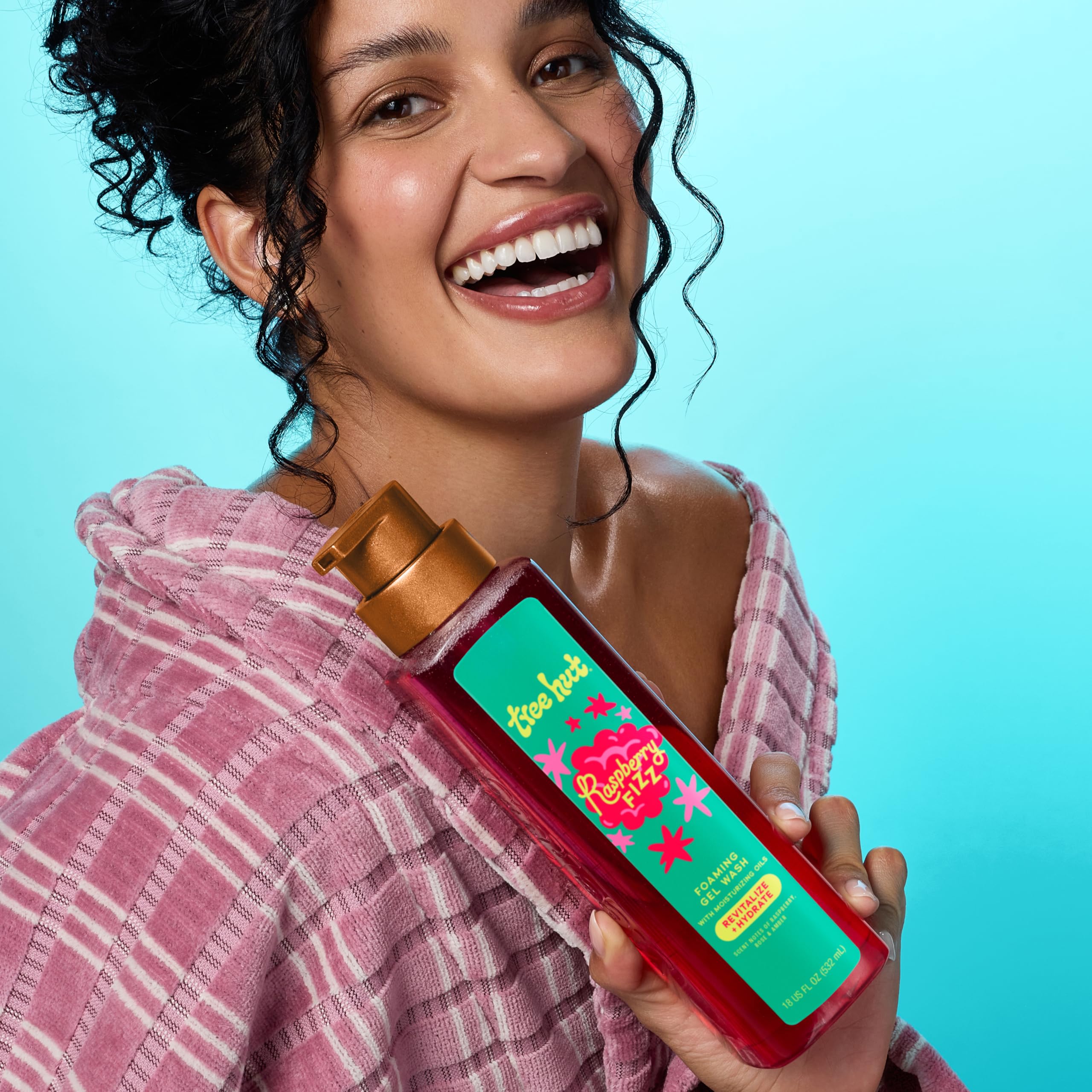 Tree Hut Raspberry Fizz bottle with rose petals scent in focus for mood