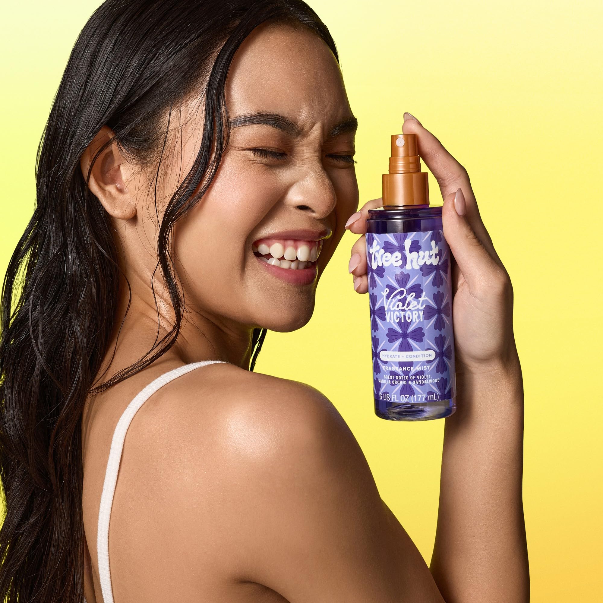 Tree Hut Violet Victory fragrance mist displays soft purple glow around bottle suggesting violet sandalwood notes.