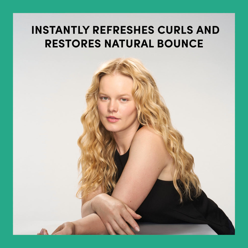 TRESemmé Bouncy Curls Leave-In Refresher spray on damp hair for defined waves.