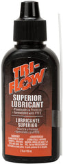 Tri-Flow nozzle close-up delivering precise lubrication to a component.