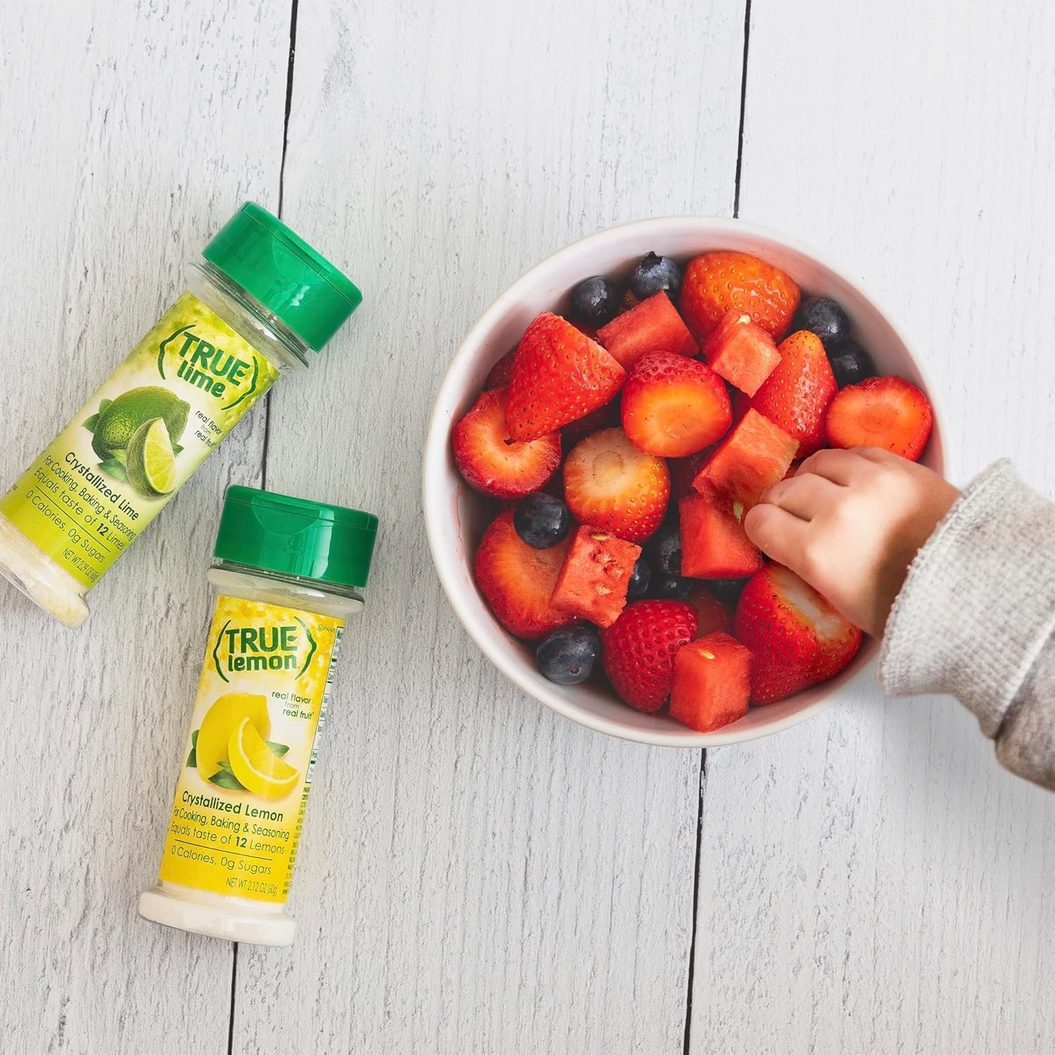 In-use scene with a water glass illustrates bright citrus notes from True Lemon.