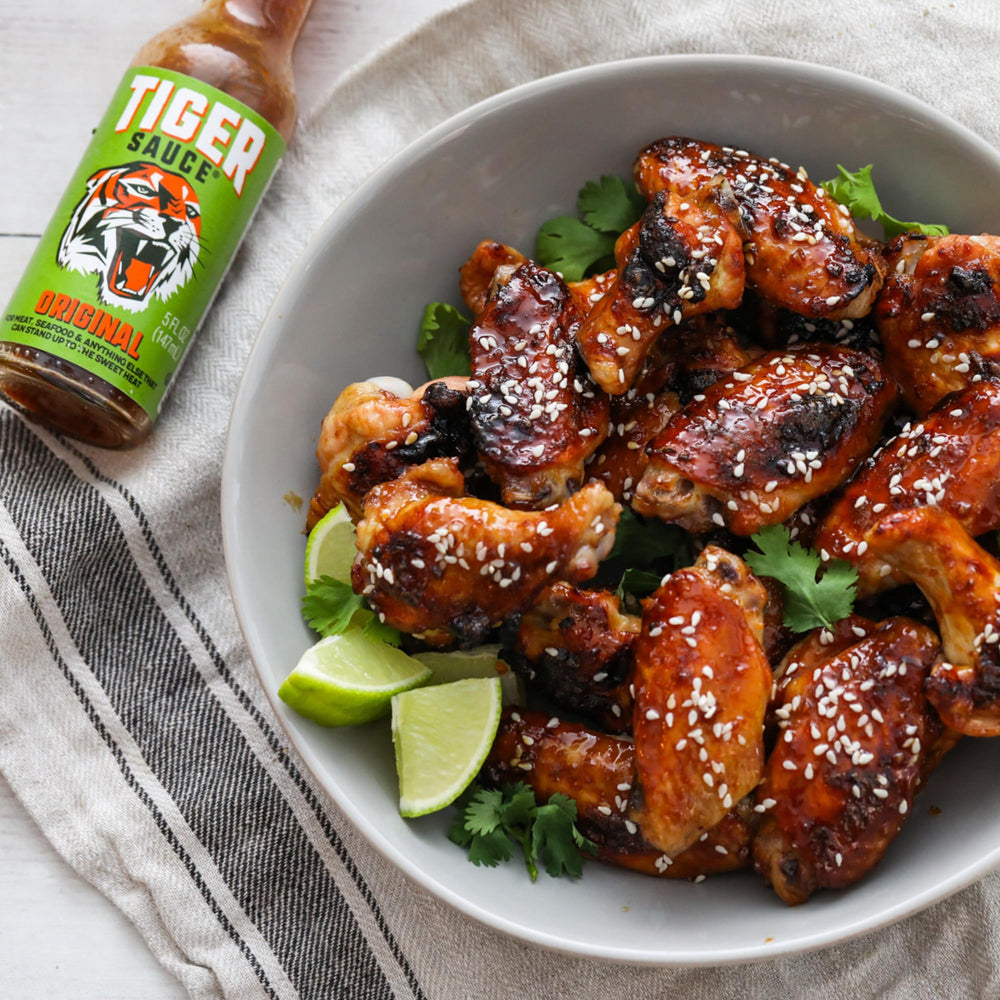 Tiger Sauce Original lid-off pour shot highlighting flexible heat and sweetness
