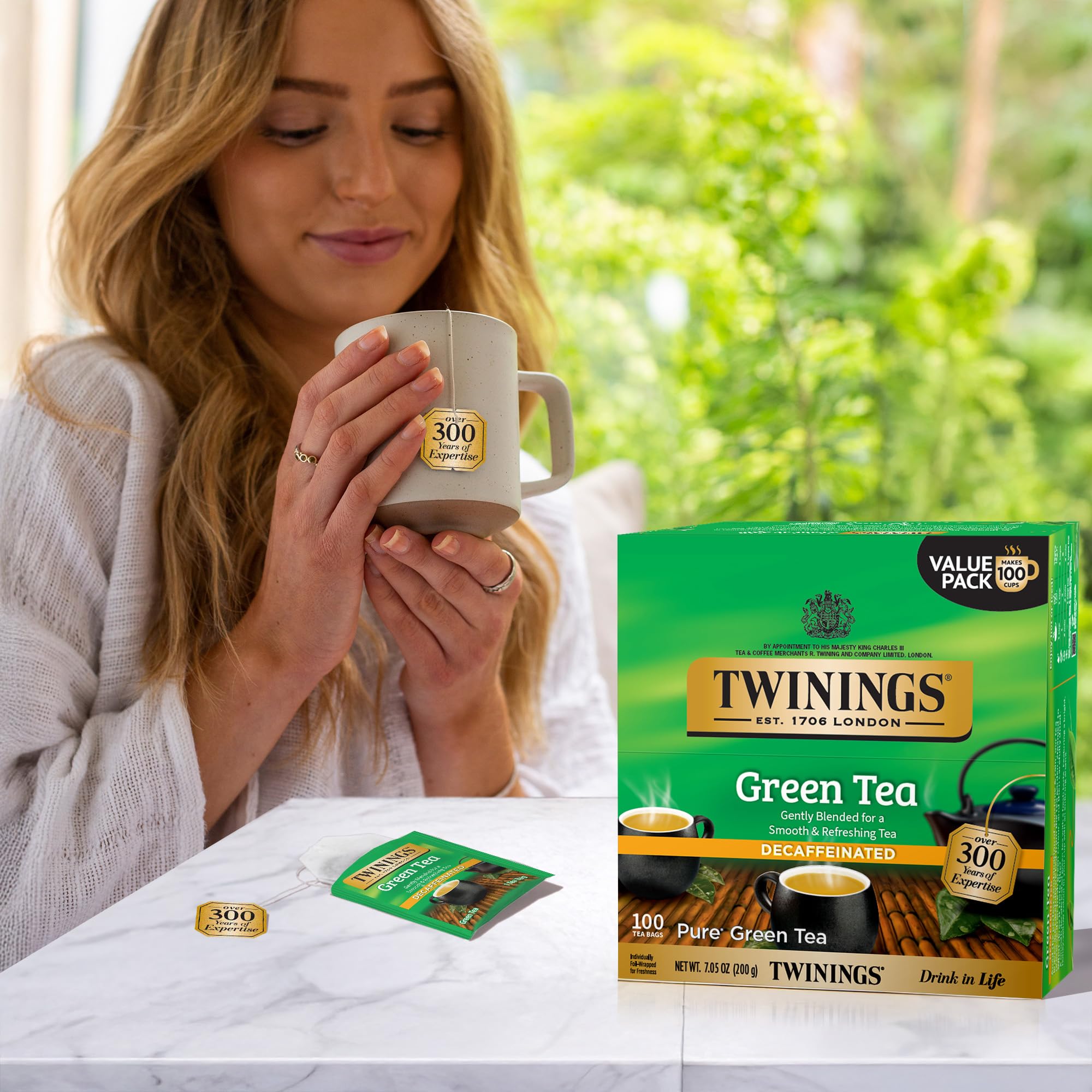 Steaming Twinings green tea brewing in a clear cup.