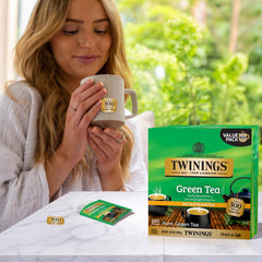 Steaming Twinings green tea brewing in a clear cup.