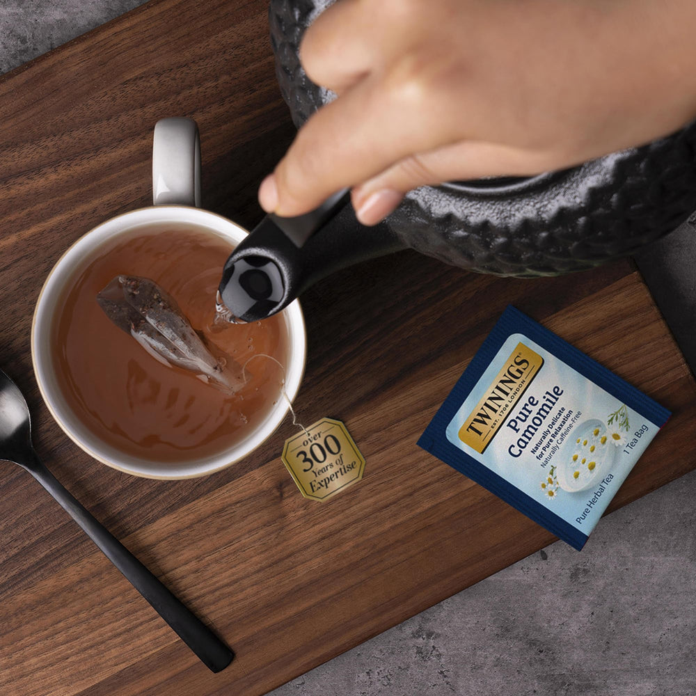 Twinings Pure Camomile soft floral aroma, inviting a relaxing tea experience.