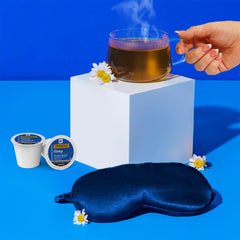 Twinings Sleep Tea K-Cups beside a Keurig brewer ready for quick hot tea.
