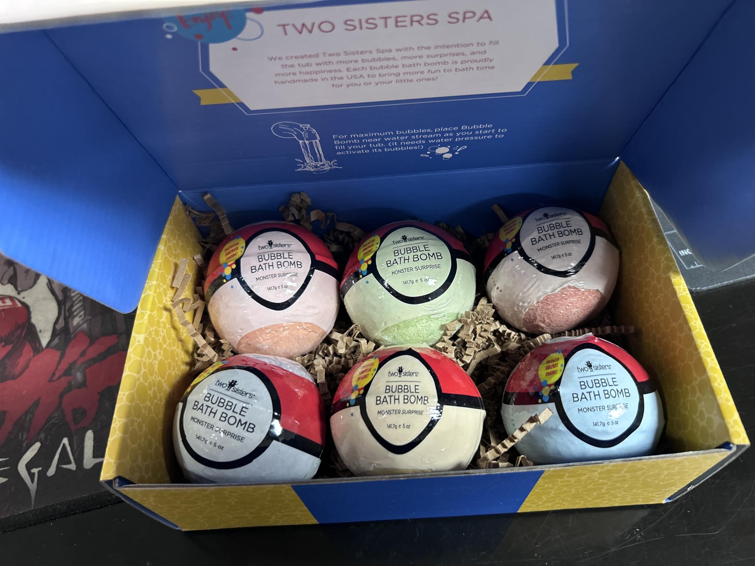 Two Sisters Poke Monster bath bomb showing surprise inside for kids' baths and collectable beasts.