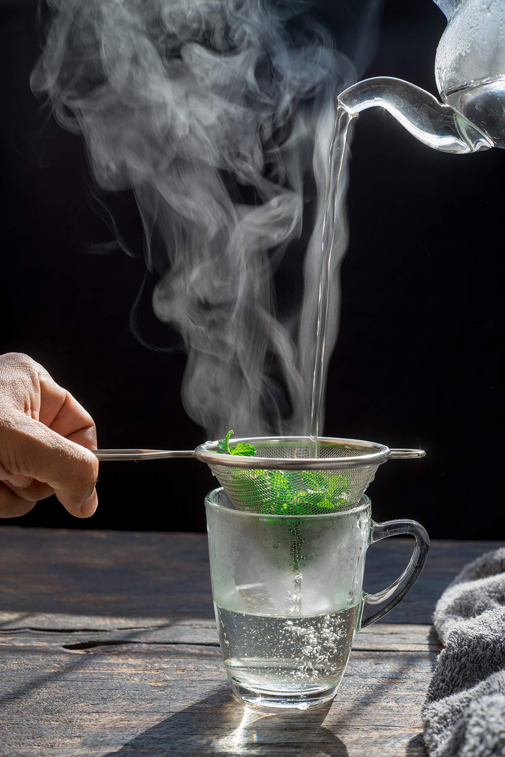 A steaming cup of U.S. Wellness Naturals peppermint tea with a refreshing aroma.