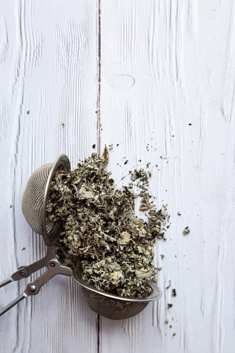 Dried raspberry leaves show texture and color from wild Albanian harvest by US Wellness Naturals.