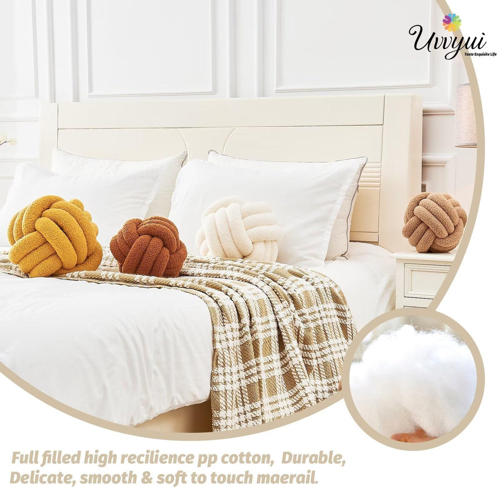 Uvvyui Knot Ball Pillow on sofa enhances warm, inviting living room ambiance.