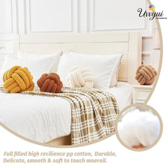 Uvvyui Knot Ball Pillow on sofa enhances warm, inviting living room ambiance.