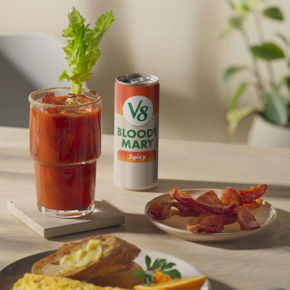 Brunch table setup with V8 Bloody Mary Spicy Mix and garnishes