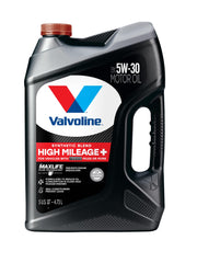 Valvoline High Mileage 150K bottle pouring oil to engine for smoother operation.
