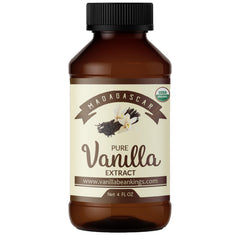 Vanilla Bean Kings Organic Vanilla Extract bottle pouring, ideal for baking and desserts.