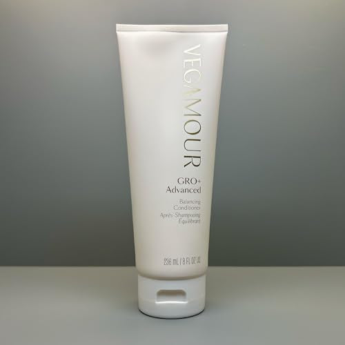 Applying VEGAMOUR GRO+ Balancing Conditioner to hair for smooth detangling.
