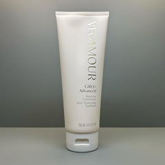Applying VEGAMOUR GRO+ Balancing Conditioner to hair for smooth detangling.
