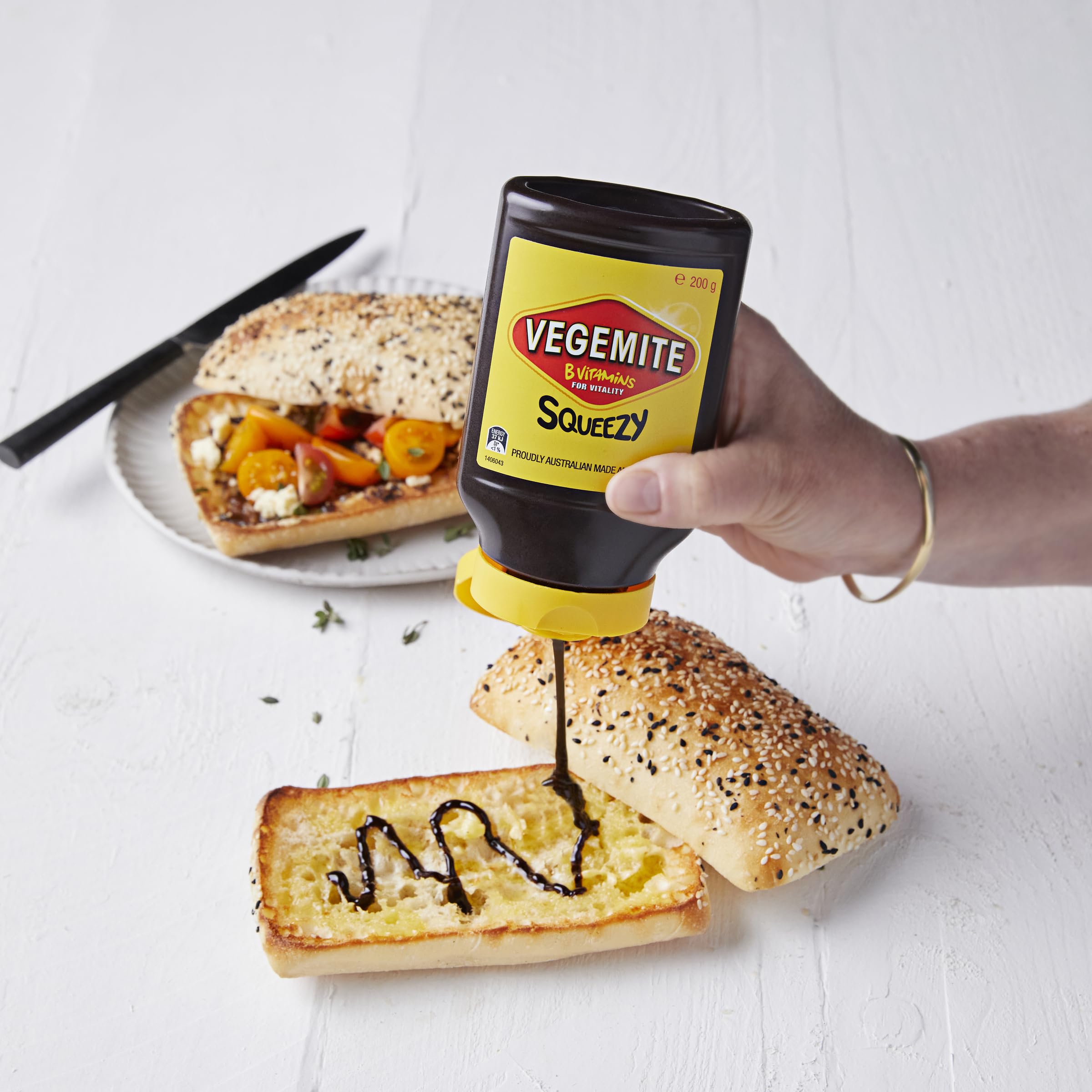 Vegemite Squeezy bottle with crackers for a satisfying snack.