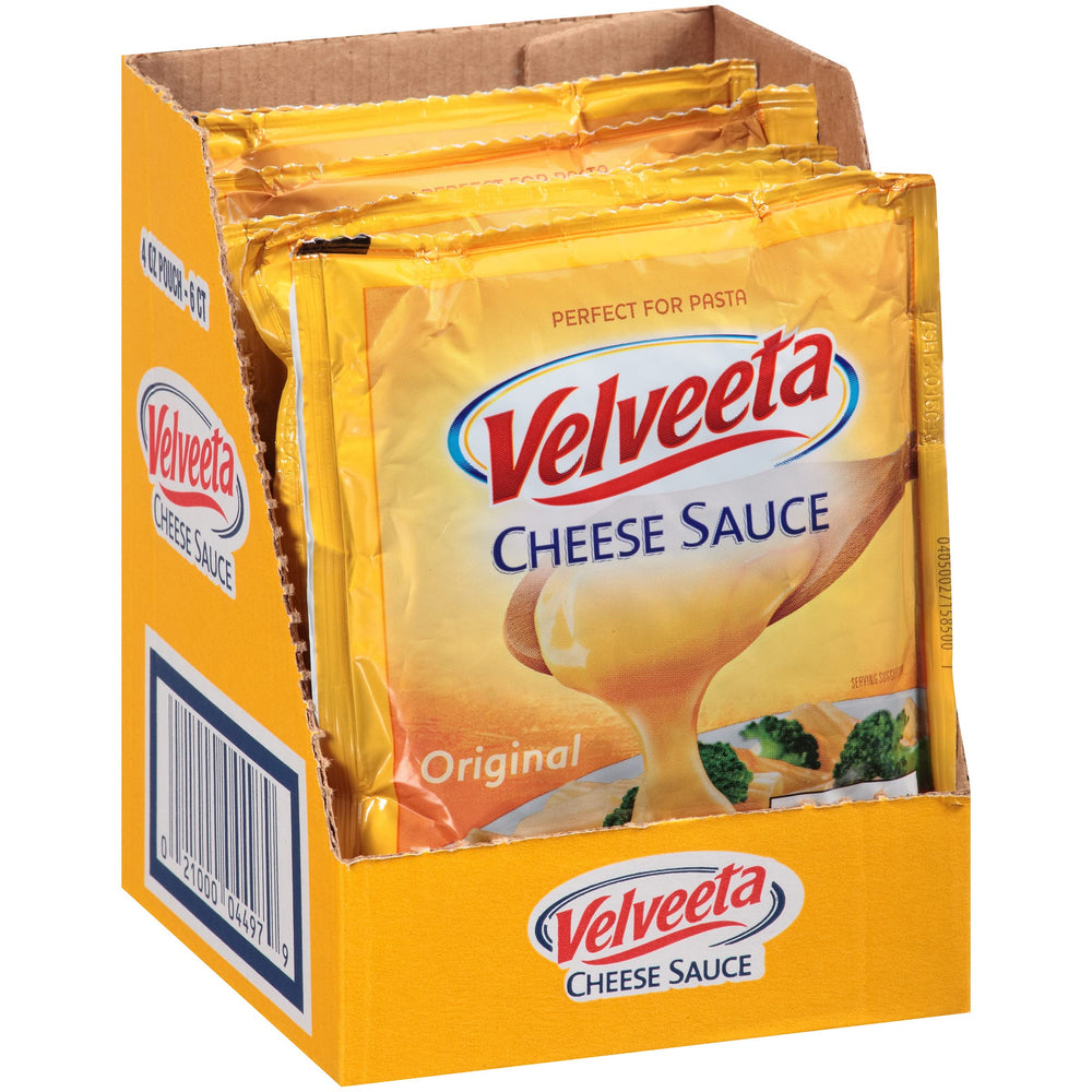 Velveeta Original Cheese Sauce Pouches over nachos for creamy topping.