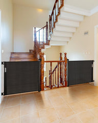 Veraste retractable gate on a stairway shows a tall barrier for stair safety.