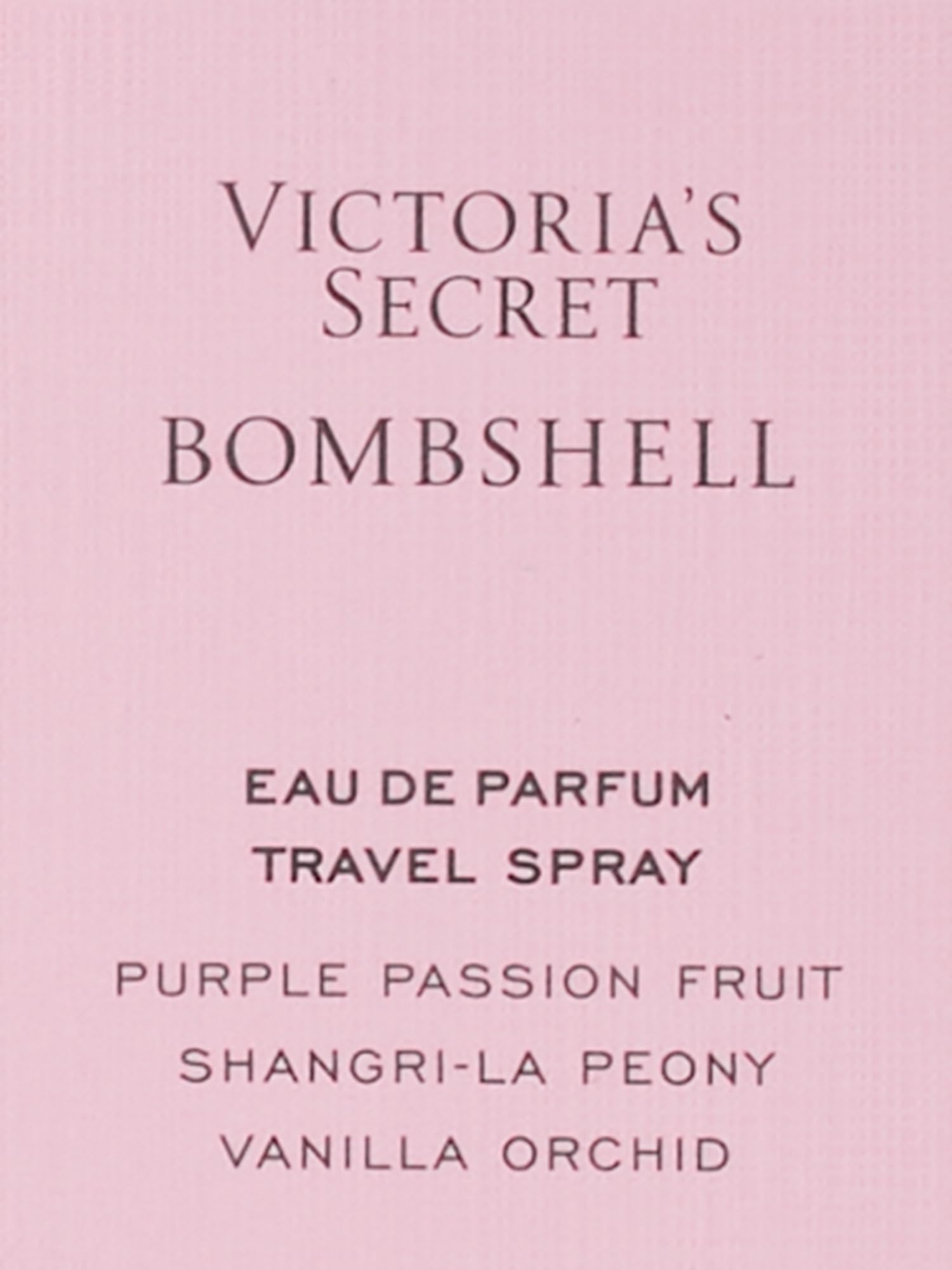 Victoria's Secret Bombshell travel spray in hand for quick refresh.