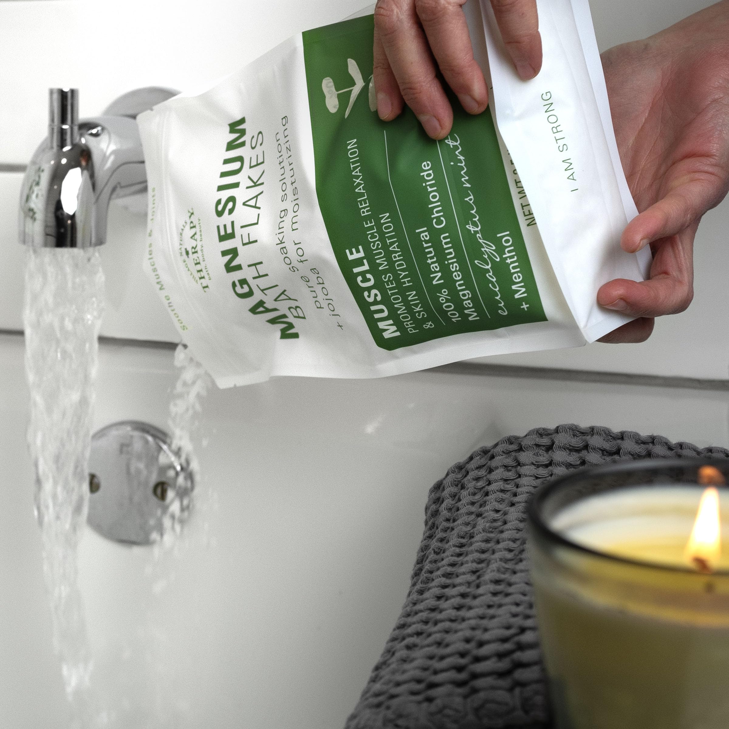 Village Naturals Therapy Muscle Magnesium Bath Flakes in a relaxing bath scene.