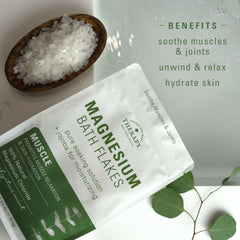 Village Naturals Therapy Muscle Magnesium Bath Flakes dissolving in tub for fast-acting soak.