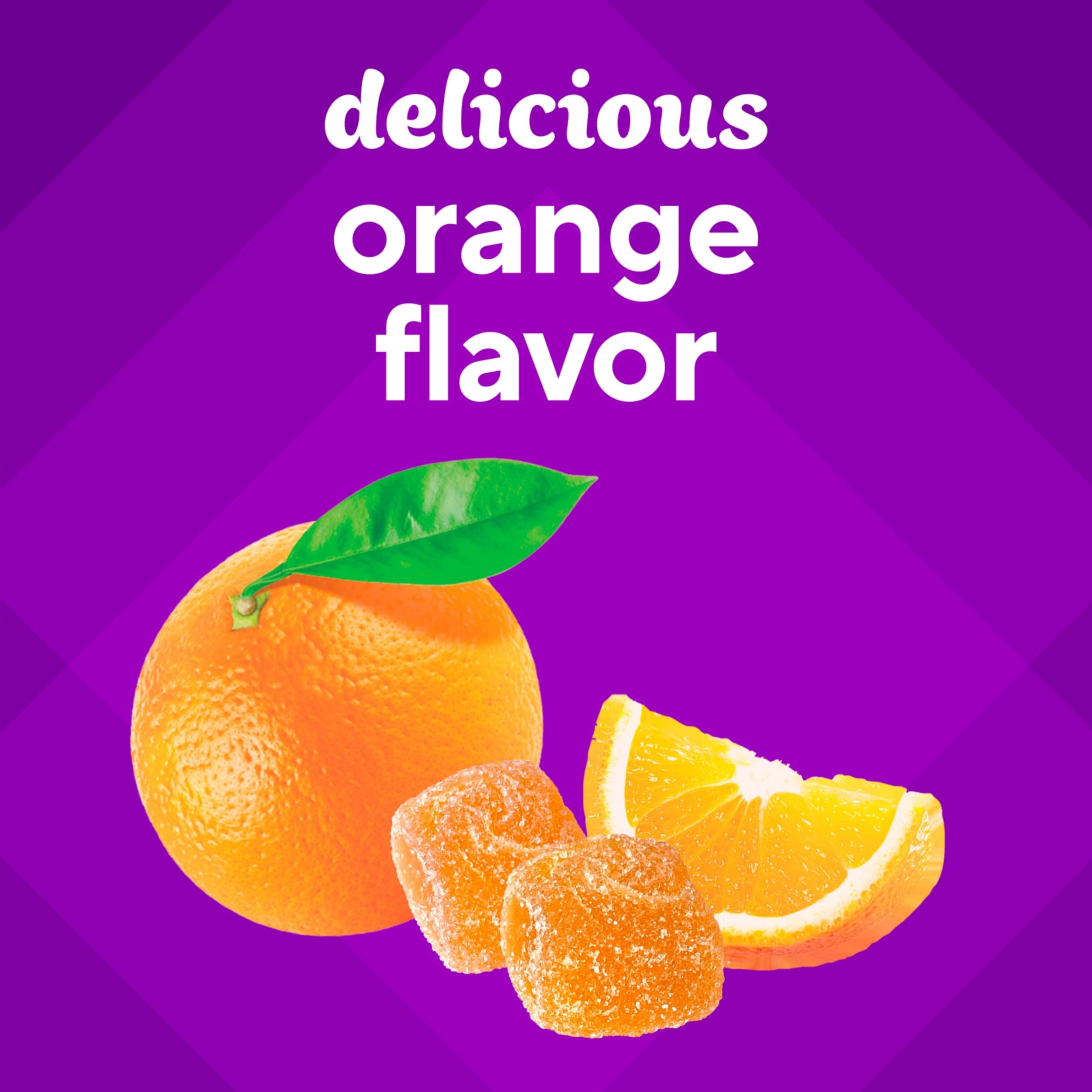 Vitafusion tropical citrus flavor with fresh fruits in view.