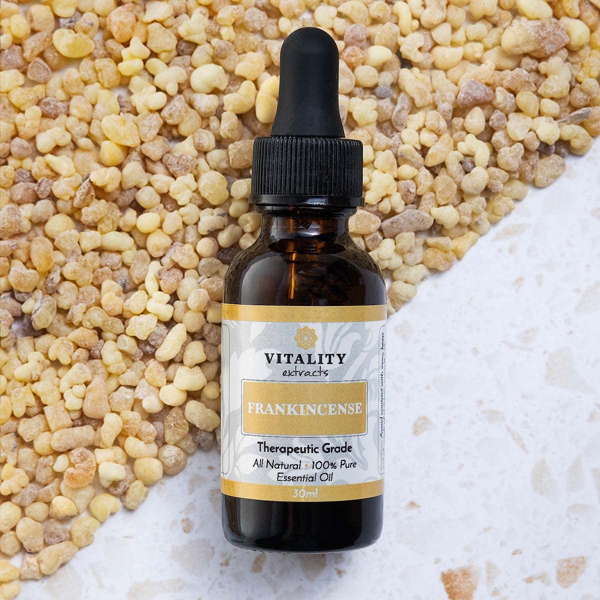 Vitality Frankincense bottle close-up with embossed branding.