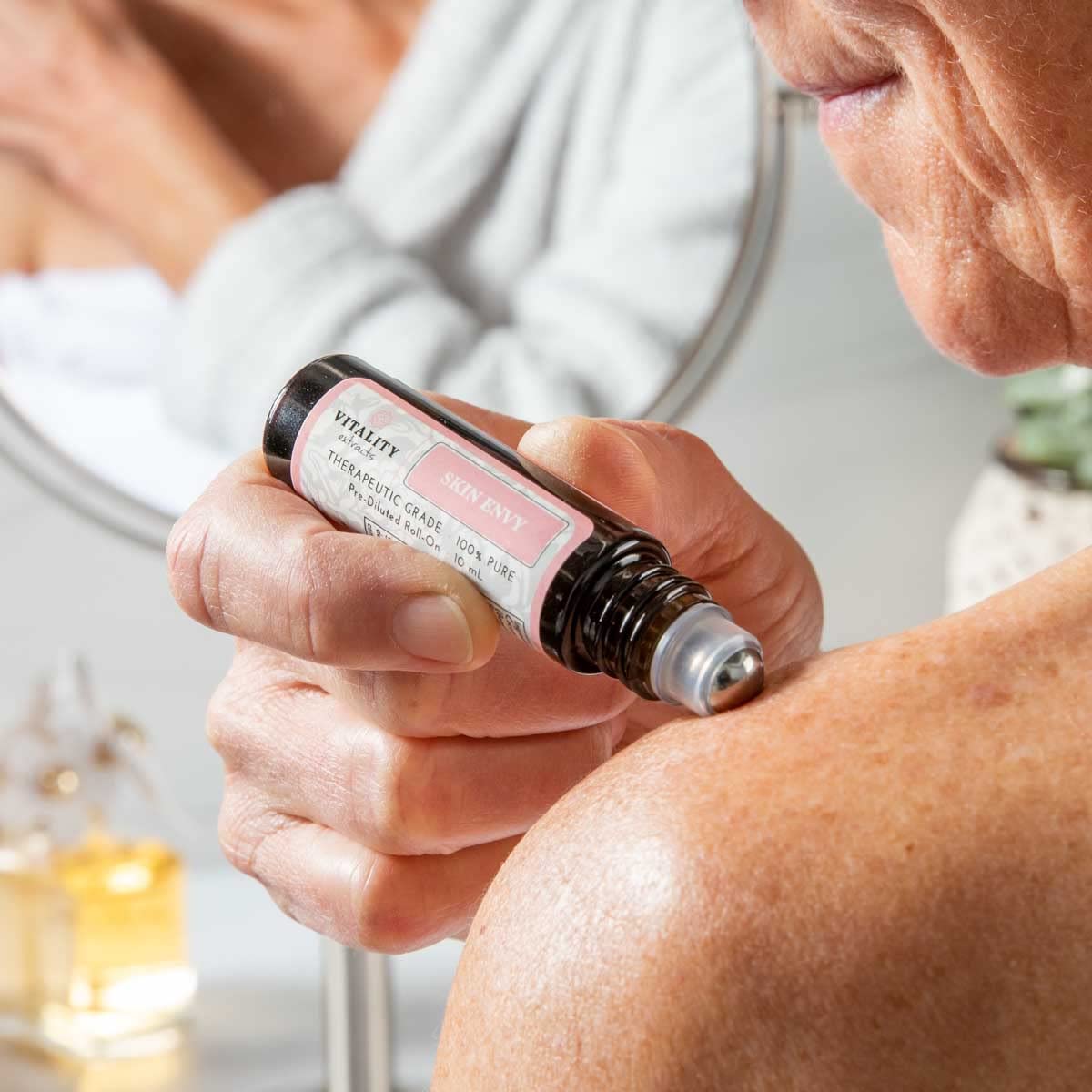 Vitality Skin Envy packaging on desk emphasizes vegan, clean ingredients.
