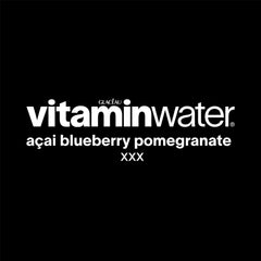 Chilled Vitaminwater XXX Açai Blueberry Pomegranate glass ready to sip.