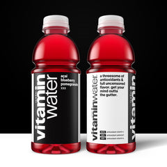 Pouring Vitaminwater XXX Açai Blueberry Pomegranate into a glass for hydration.